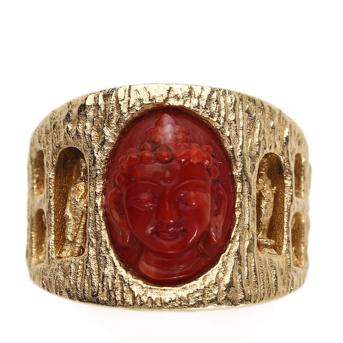 A 20TH CENTURY CORAL BUDDHA RING IN 18K GOLD: DIMENSIONS: Inner diam: 16.8 mm; Weight: 14.2 g DESCRIPTION: This striking ring features a finely carved coral cameo of a serene Buddha head in high relief, set at the center of a wide textured 18K go