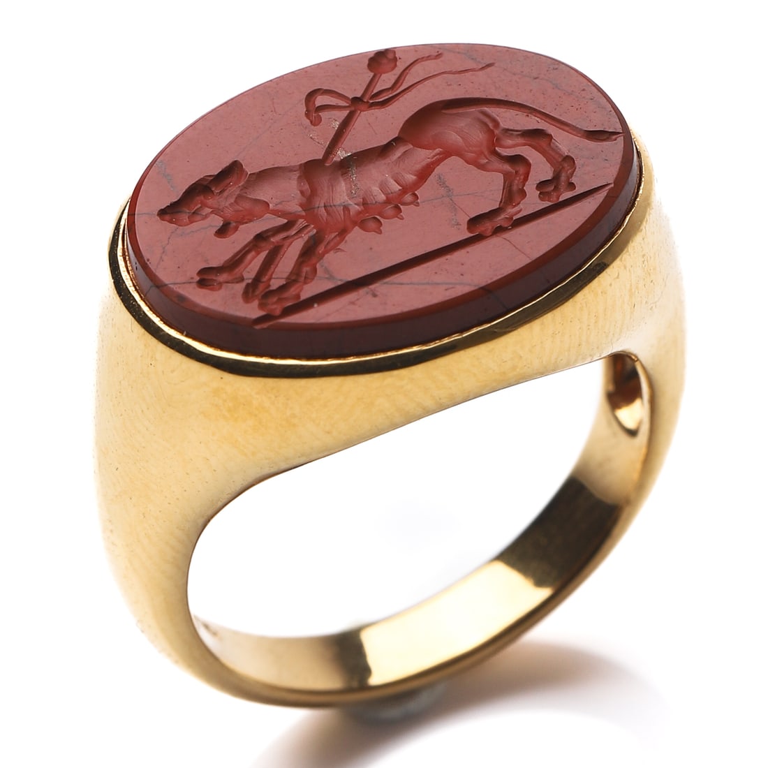 18K GOLD SIGNET RING WITH RED JASPER INTAGLIO.: Dimensions Inner diameter: 3/4 in (18.8 mm); Weight: 10.9 g Description An 18k gold signet ring set with an oval red jasper intaglio finely carved with a striding bull beneath flowing ribbons. The smo