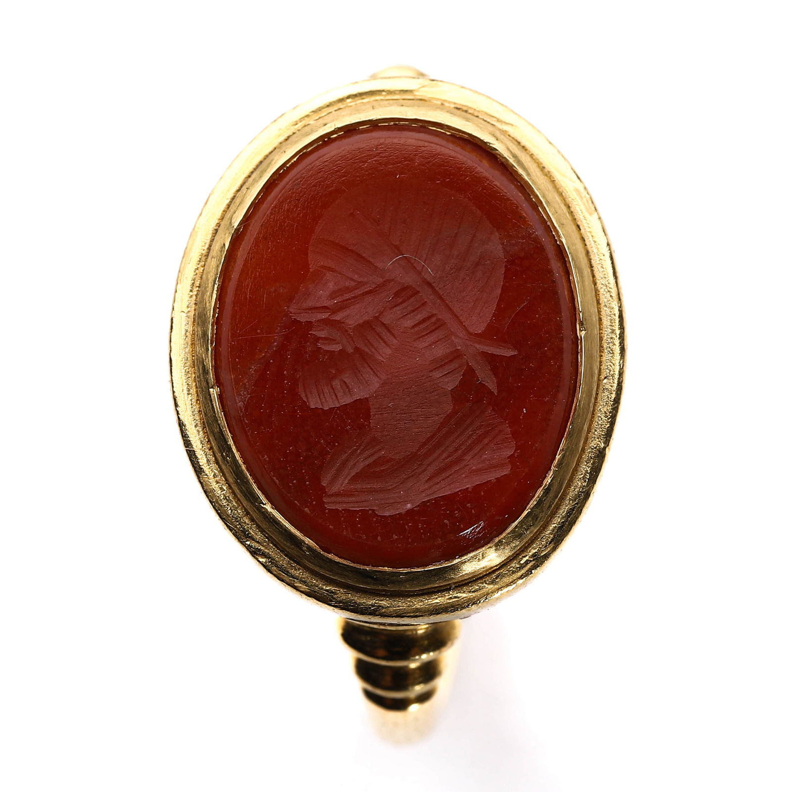 A 22K GOLD CARVED CARNELIAN INTAGLIO RING.: Dimensions: Length: 3/4 in. (1.9 cm), Width: 1/2 in. (1.3 cm), Weight: 2.6 g. This elegant 22k gold ring features a beautifully carved carnelian intaglio with a bust of a male figure. The intricate de