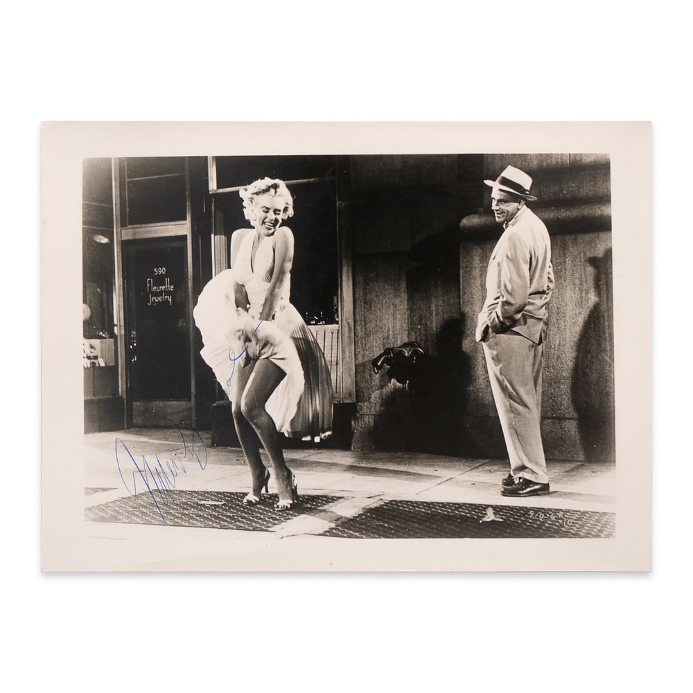 MARILYN MONROE SIGNED GELATIN SILVER PHOTOGRAPH: 6 1/2 x 4 3/4 in (16.5 x 12.1 cm) This signed gelatin silver print captures one of the most enduring and iconic moments in twentieth-century American cinema. Marilyn Monroe stands over the subway grat