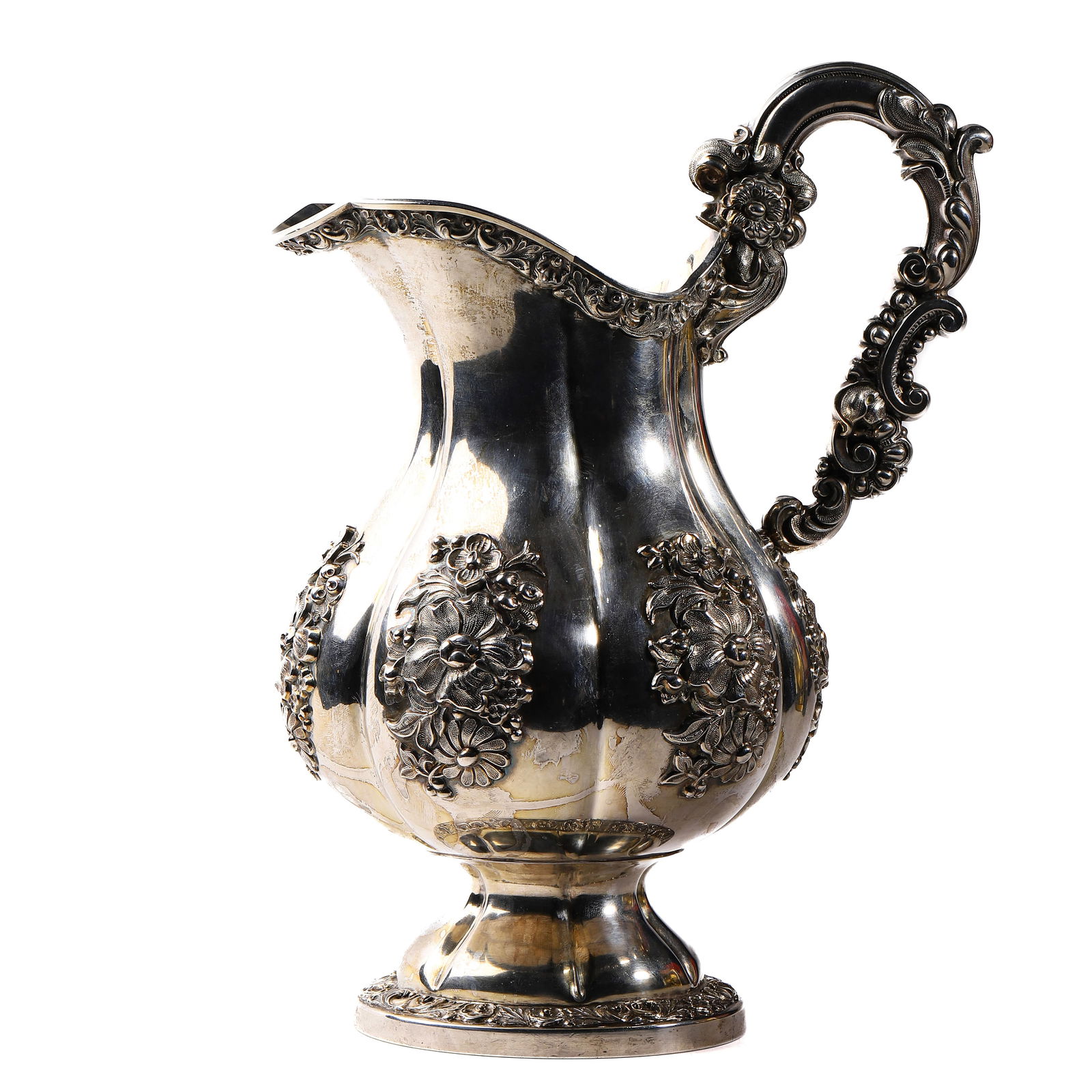 A VICTORIAN SILVER REPOUSSÉ WATER PITCHER (1 of 7)