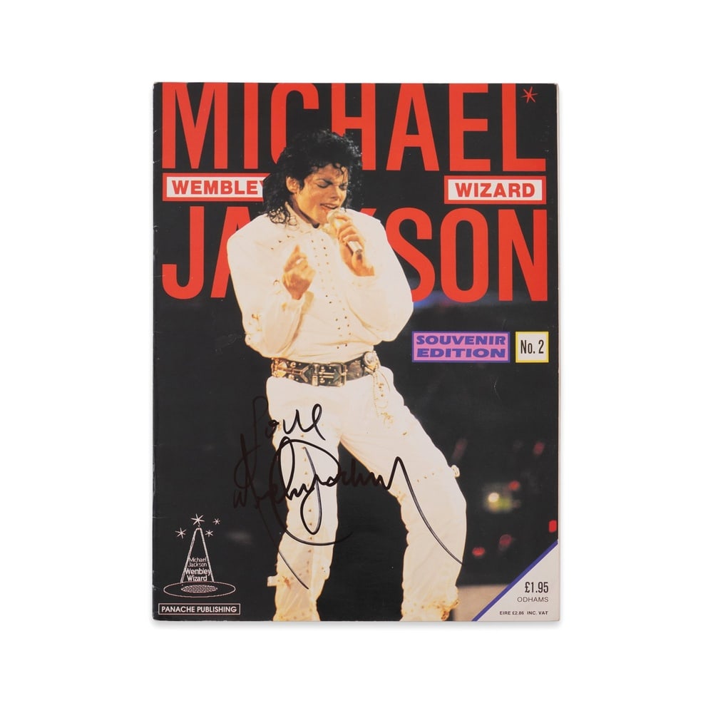 MICHAEL JACKSON SIGNED "WEMBLEY WIZARD" SOUVENIR EDITION NO. 2: 11 3/4 x 8 1/4 in (29.7 x 21 cm) Provenance and Authentication: This collectible has undergone a rigorous forensic evaluation. The signatures were carefully analyzed across multiple criteria, includin