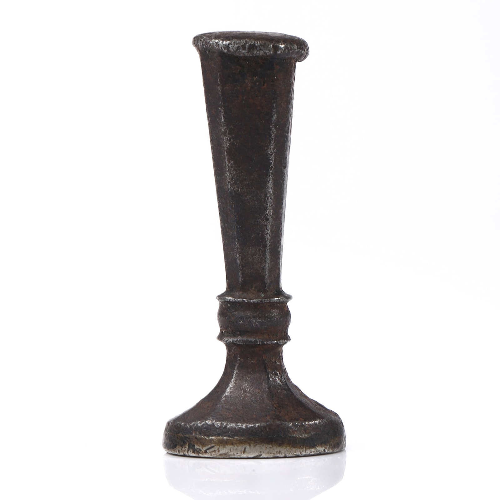 A BRONZE HERALDIC SEAL: Dimensions Height 1 3/4 in (4.5 cm); Weight 29.4 g. Description A bronze seal with a tapered cylindrical handle rising from a rounded base, showing an aged dark patina. The seal matrix is engraved wit