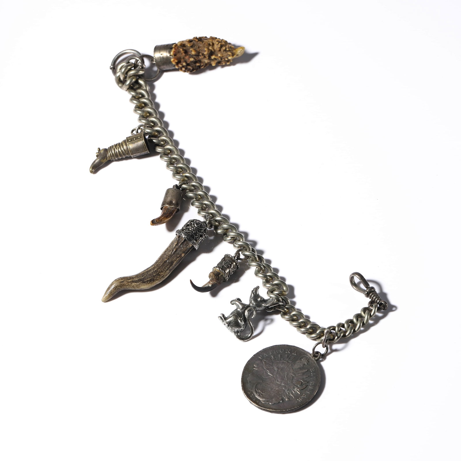GERMAN, BAVARIA, 20TH CENTURY — TRADITIONAL LADIES’ CHARIVARI JEWELRY.: GERMAN, BAVARIA, 20TH CENTURY — TRADITIONAL LADIES’ CHARIVARI JEWELRY. Medium: Silver with animal claws, antler fragments, coin, and hunting charms Dimensions: Length: 13 3/8 in. (34 cm); Weight: 