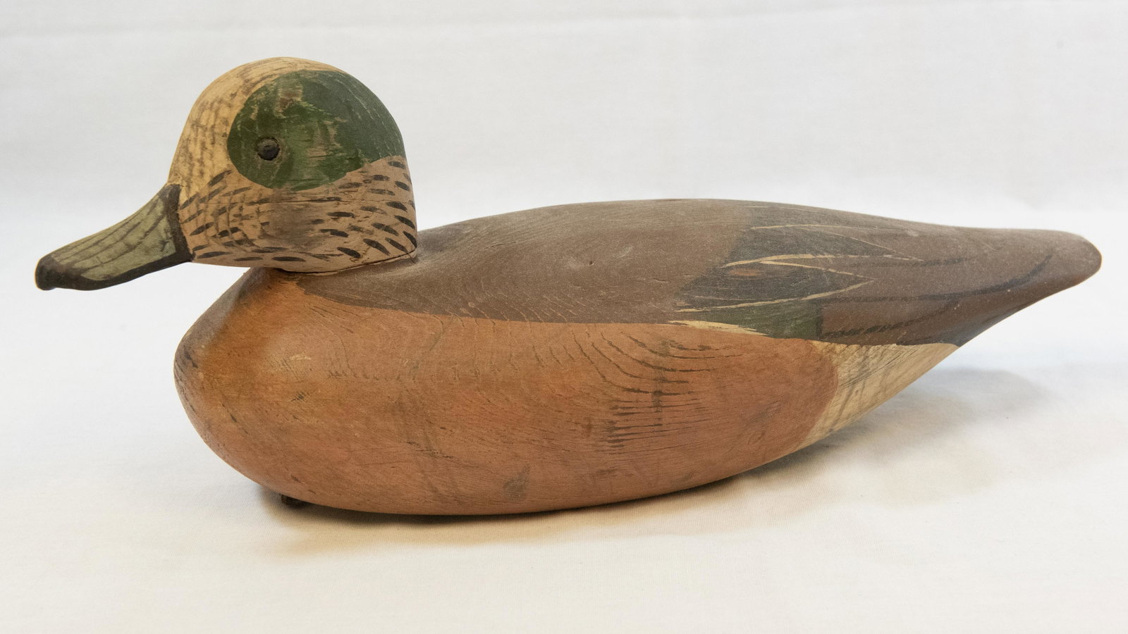 DUCK DECOY with Shades of Tan and Green Bill: DUCK DECOY with Shades of Tan and Green Bill and Glass eyes. There is also a green patch around the eyes. No Visible signature. Possibly marked with a C. No weight attached but place where one was. Le