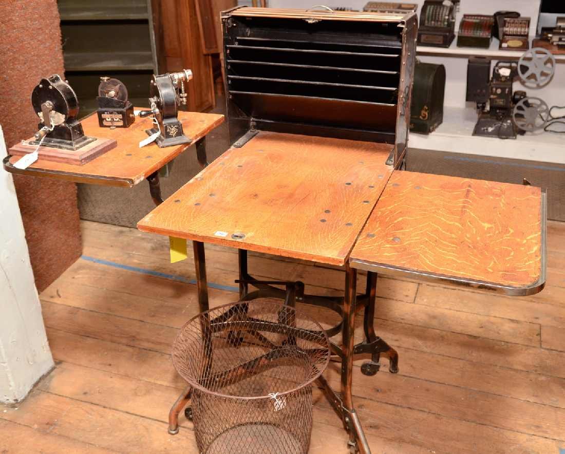 THE TOLEDO METAL FURNITURE CO ANTIQUE ROLLING TYPE: THE TOLEDO METAL FURNITURE CO ANTIQUE ROLLING TYPEWRITER STAND/ WORK STATION,"TOLEDO, OHIO, U.S.A." & "UHL ART STEEL FURNITURE". MARKS ON LOCKING METAL TAMBOR LID. OAK W/ CAST METAL BASE. PAPER STORAG
