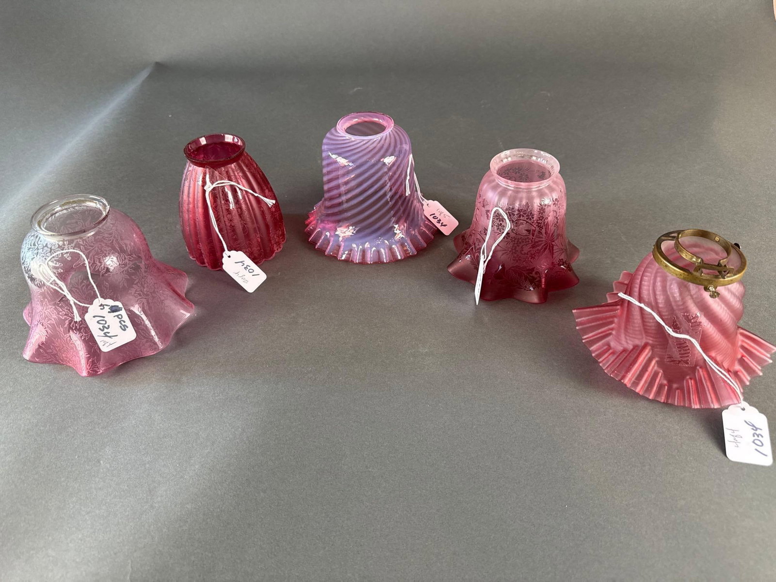 5 various cranberry glass shades: 5 shades from early glass lite fixtures 2 matching Low Estimate: 25.00 High Estimate: 100.00