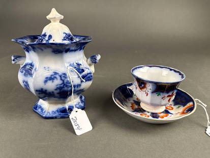 2 pieces Flow Blue St.Louis: Sugar bowl 8" nick on lid, early hand less cup and saucer small nick  Low Estimate: 20.00 High Estimate: 40.00