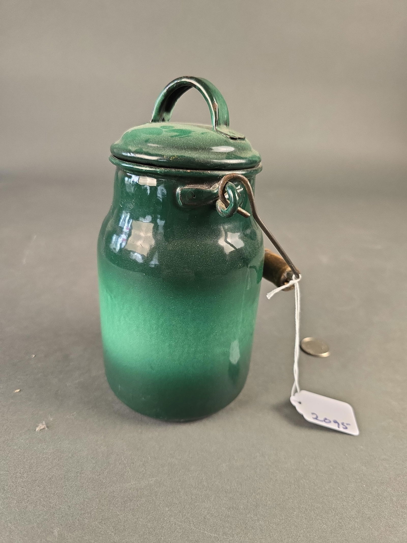 Green banded granite milk jug: 8" wooden handle Low Estimate: 30.00 High Estimate: 50.00
