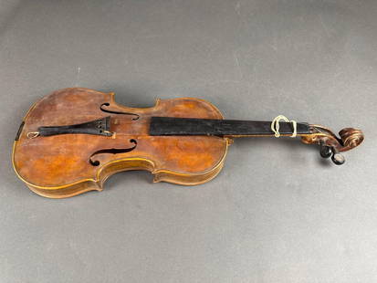 Home made violin by the Gilmore brothers of Kooskia: Early days the Gilmores had a ranch toward Elk City, after they retired they moved to Kooskia. The made violins in their spare time. Needs glued back together.  Low Estimate: 50.00 High Estimate: 100.