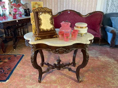 Marble turtle top walnut center table 1870s: 39" long, 28" high, 26" wide  Low Estimate: 100.00 High Estimate: 300.00