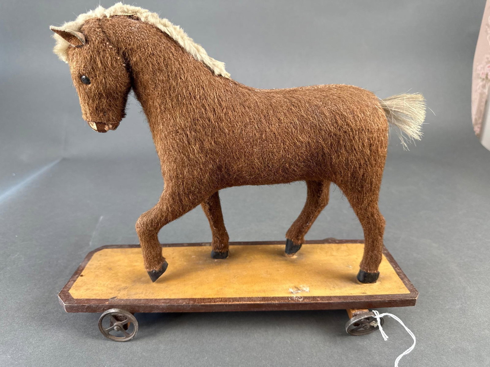 Mohair horse on platform with wheels: 14" L Low Estimate: 50.00 High Estimate: 100.00