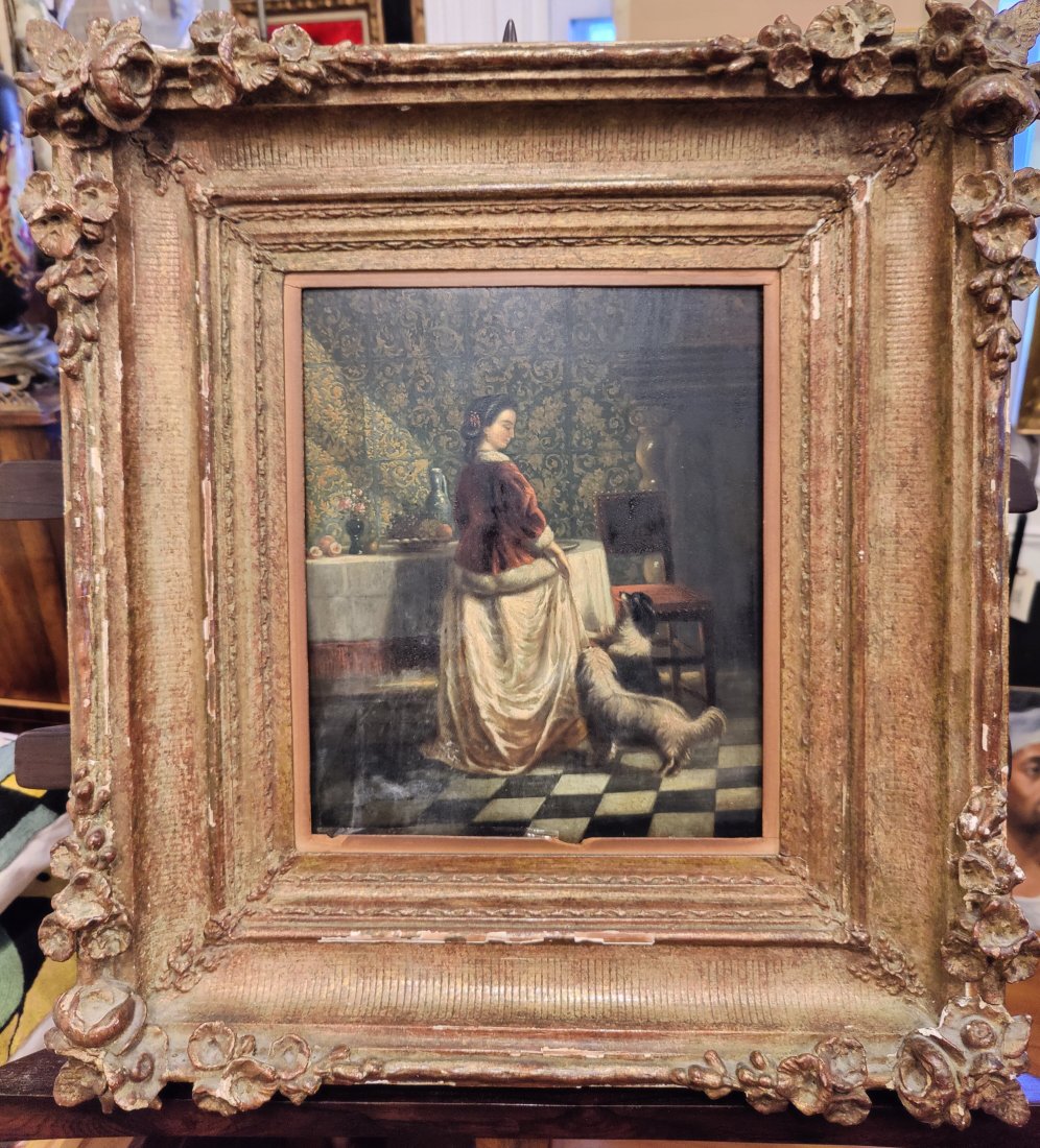 Victorian Interior Scene O/P Woman with a Pair of Dogs: Good condition painting and ornately framed. Needs a cleaning. Frame has display wear.