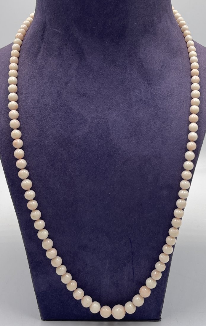 Vintage Graduated Angel Skin Coral Necklace with 18k Pearl Clasp: Beautiful graduated angel skin coral necklace with an 18k gold bow shaped clasp with single pearl. 26" long. Total weight 39.0 grams.