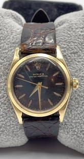 Vintage Solid 14k Yellow Gold Rolex Unisex Automatic Watch: 1960s unisex Rolex Oyster perpetual solid gold watch. Original Rolex band and buckle. 27 mm wide, 33 mm high. Running well and keeping time.