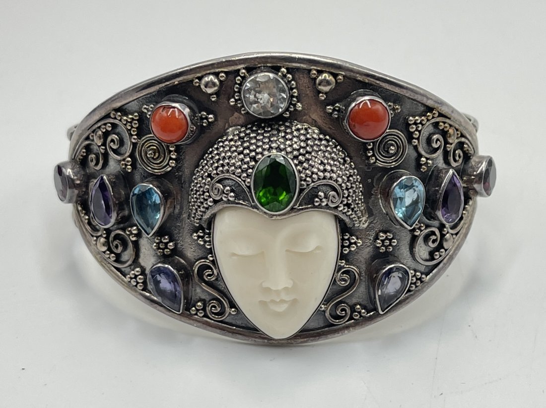 Vintage Sterling Silver & Multi Gemstone Cuff Bracelet: To include amethyst, coral, blue topaz & garnet, with a hand carved bone face. Inside circumference measures 6" with a 1" gap. Total weight 46.2 grams.