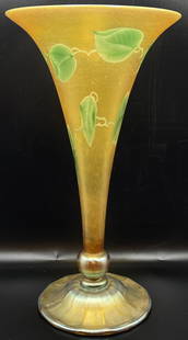 Large Tiffany LCT Favrile Art Glass Vase: Gold favrile vase with green etched leaf designed. Excellent condition. Signed "1867J LC Tiffany Favrile." Measures 13 1/2" tall.