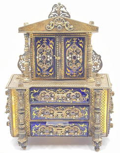 Reuge Gem Set Gilded Sterling Silver Jewelry Music Box: Reuge gem set gilded sterling jewelry music box, early 20th C., garnet and pearl bezel set cabochons atop gilt cobalt blue enamel panels, signed "Reuge" on base, chased and engraved exterior with scro