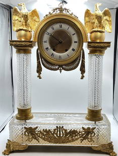 Magnificent Baccarat Empire Revival Dore Bronze Clock: 19th Century Dore Bronze empire revival mantle clock with Baccarat glass pillars and base. Highly detailed eagles and very fancy dial. Pendulum may not be original. Running. (see pics) 24" high x 17 .