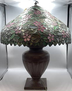 Signed Handel Leaded Glass Table Lamp: Beautiful floral pattern leaded glass shade, signed Handel on patinted metal base. Base also signed Handel. Hubble sockets with acorn pulls. Overall very good condition. 24" to the top of the finial,