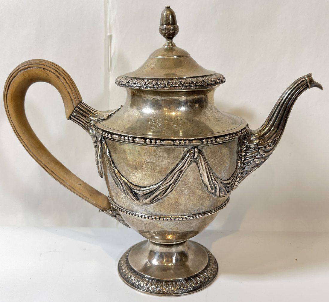 c1775 London Sterling Silver Teapot: Dated 1775, crown on the lion passant, maker appears to be I C or I D. Handle is wood. Total weight 841.3 grams. Overall very good condition,