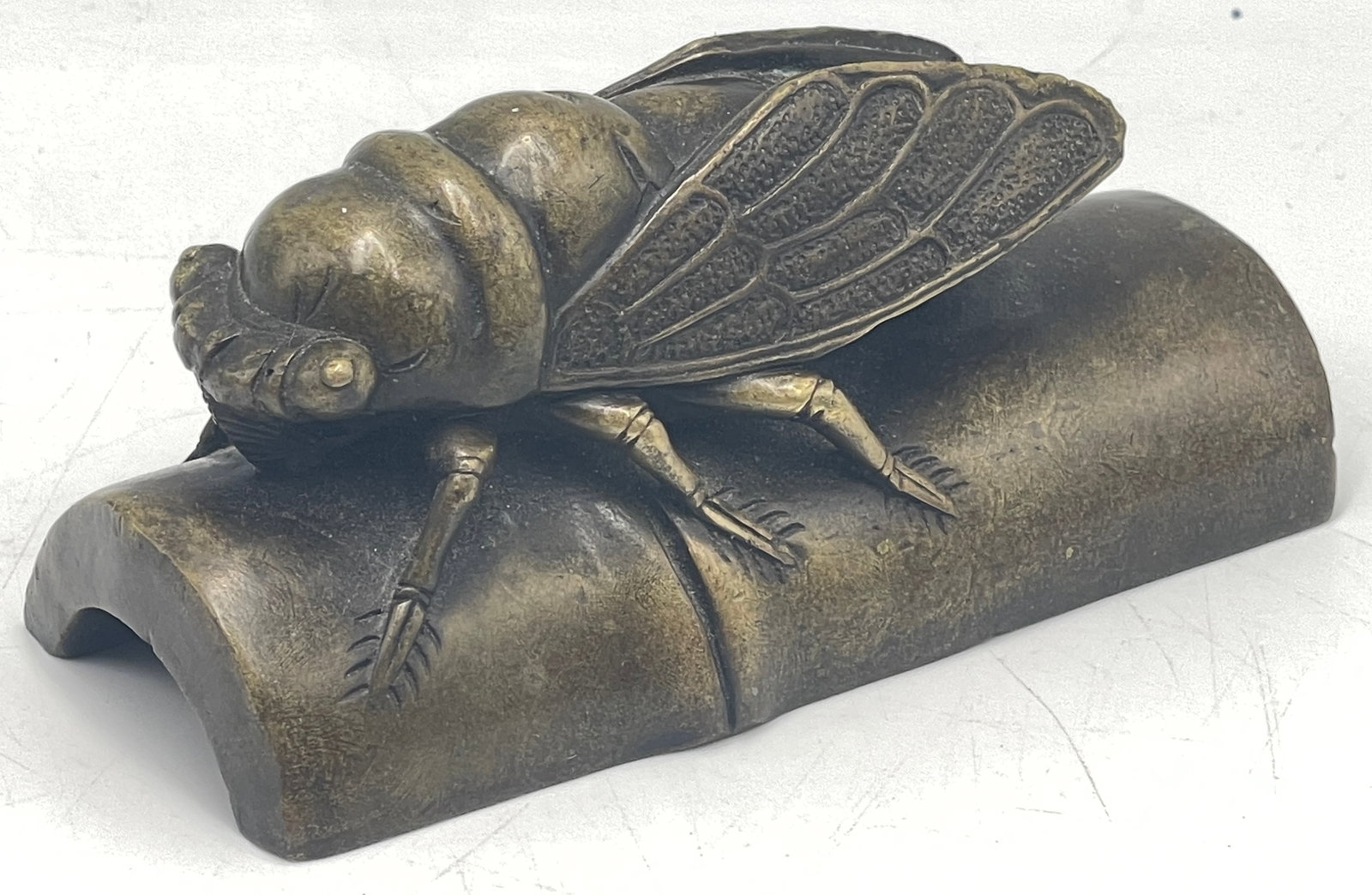 Japanese Bronze Okimono Model of Cicada: Japan, Meiji period (1868-1912) bronze cicada sitting on bamboo. 4 in long, 1.75 in wide, 2 in high.