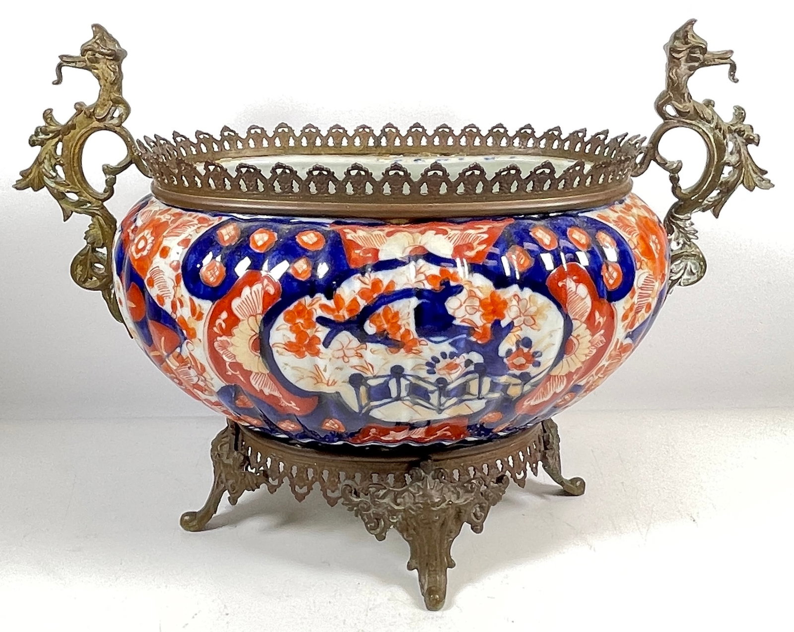 19C Japanese Imari Porcelain bowl With Gilt Mounts: 10 in high, 15 in wide, 9 in deep. No chips or cracks, overall very good condition.