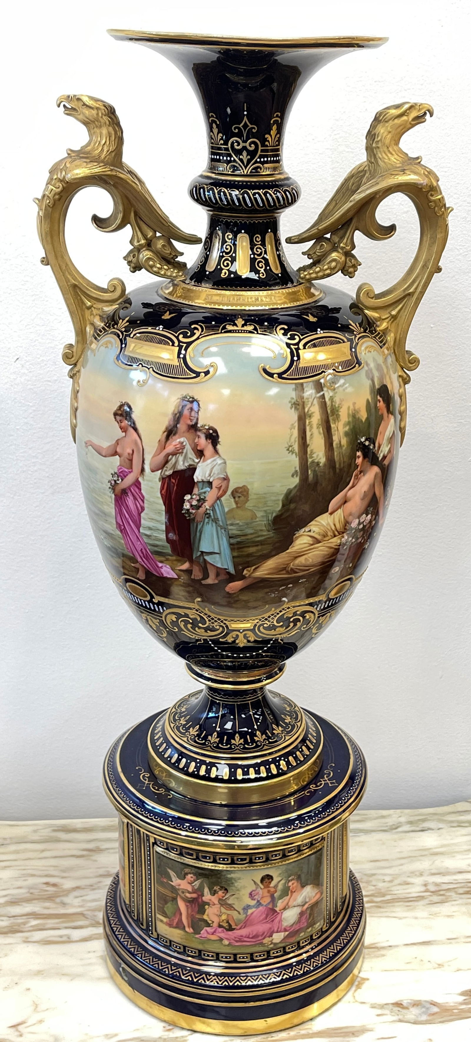 Exceptional 19C KPM Cobalt Blue Porcelain Nude Scenic Vase: Raised on pedestal with three scenic panels to include a nude, large figural eagle handles with scene continued all the way around. Top rim raised gold lettering "St. Johannis Nacht" on one side, "Nac