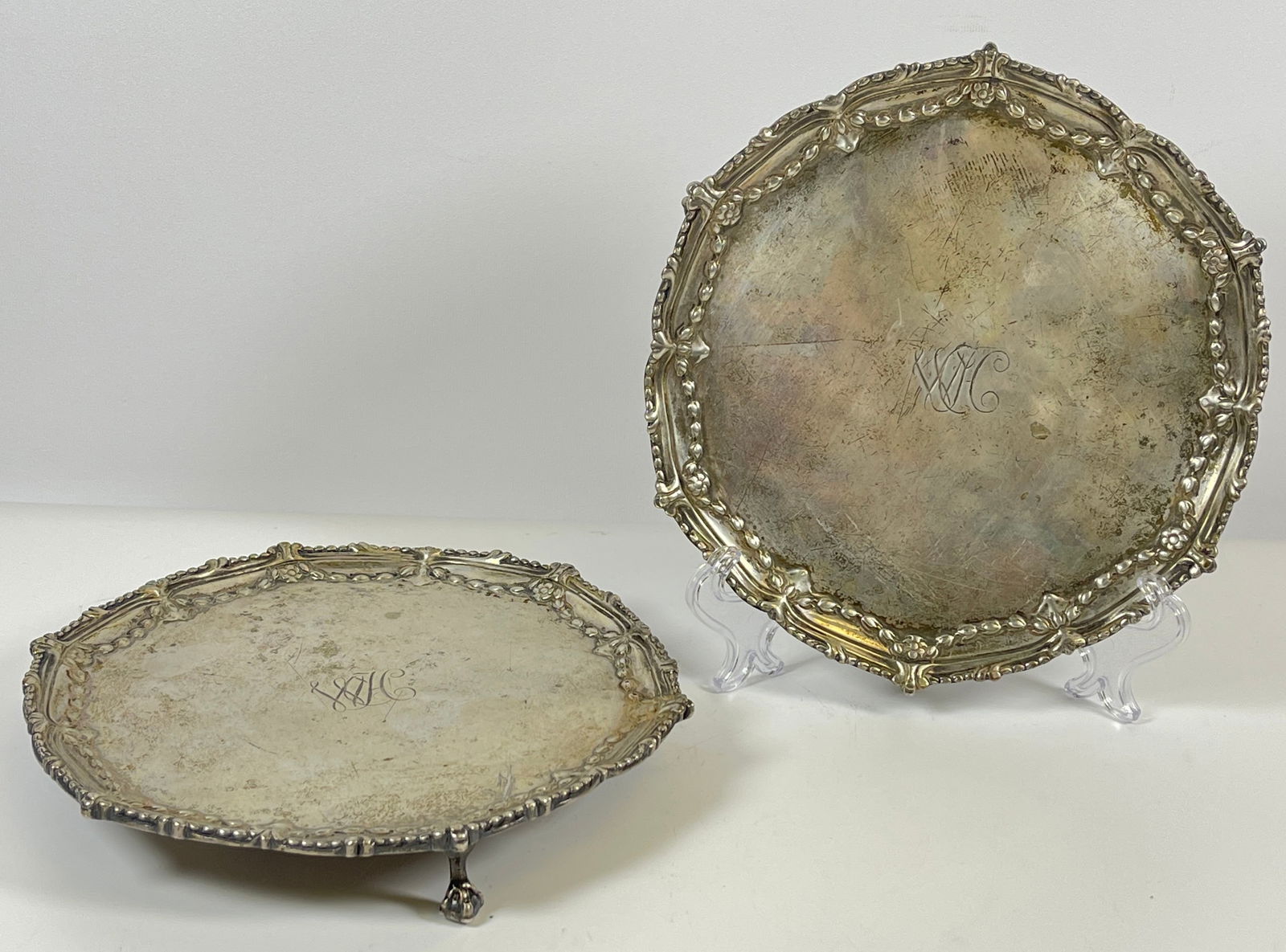Pair c1770 John Carter London England Sterling Silver Footed Salvers: Hallmarked for London, dated 1770, maker IC for John Carter. Heavy wear, some bending expected with age. Monogrammed. Total weight 18.3 troy ounces. Measure 7.5 inches in diameter.