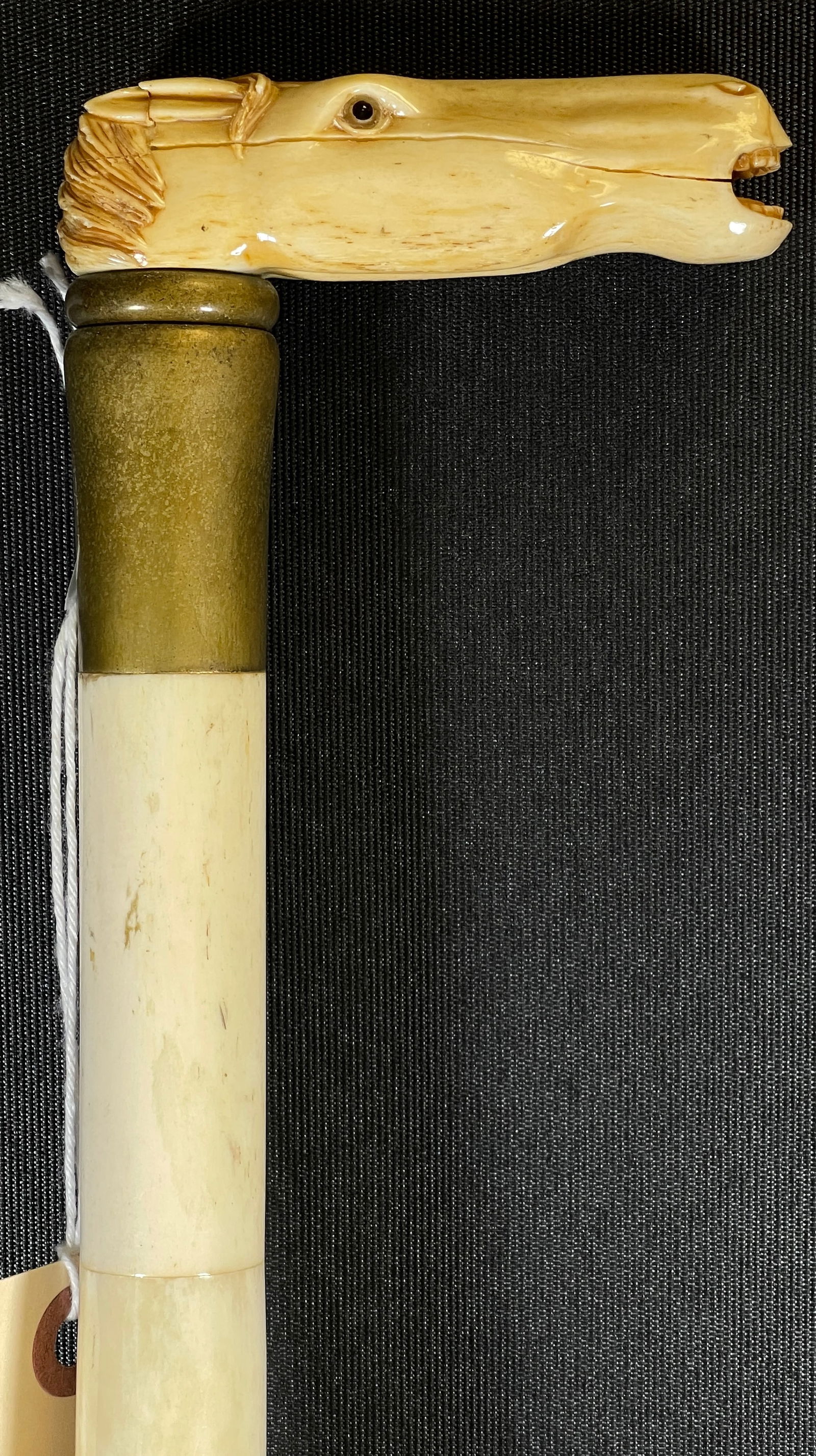 Vintage Carved Bone Walking Stick Depicting Horse Head: Bone shaft, brass tip. 36 in long. Some sections separated, please see photos.