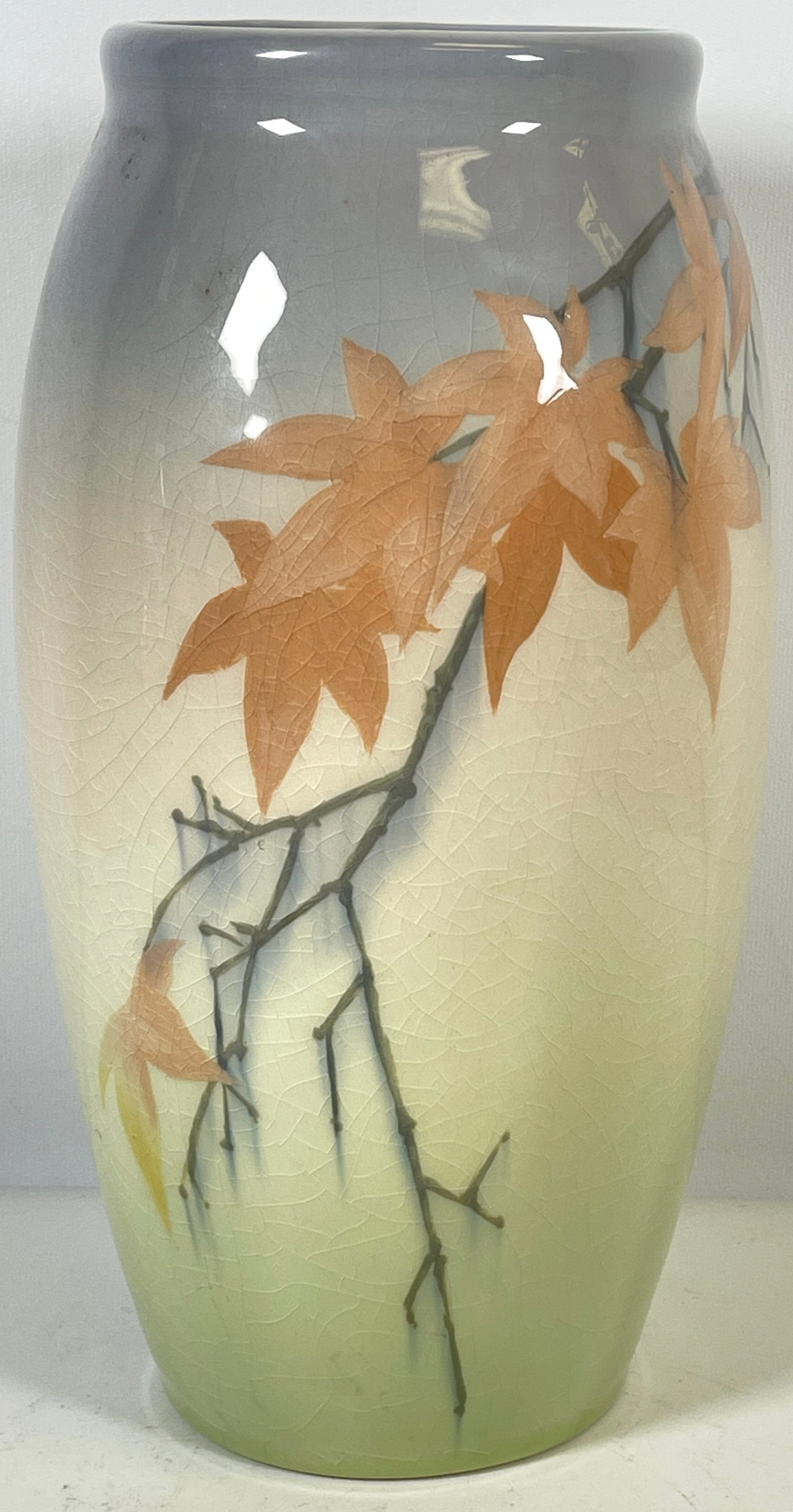 c1912 Sallie Coyne Rookwood Art Pottery Vase: Soft pastels of blue and pink, marked on the bottom. Overall good condition with crazing thoughout. Please see photos. Measures 9.25 inches high, 5 inches in diameter.