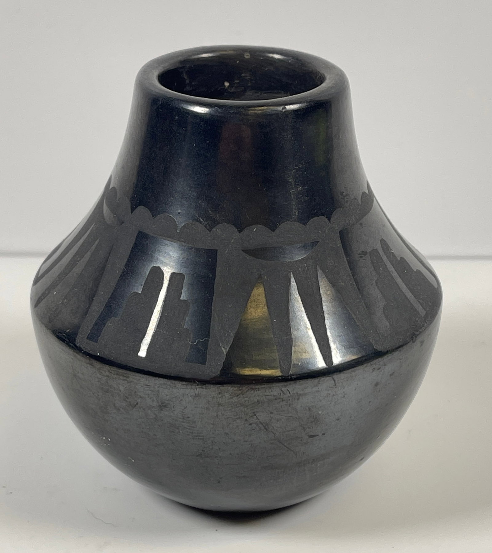 Adam & Santana Martinez San Ildefonso Pottery Jar: Adam & Santana Martinez San Ildefonso Pottery Jar, black on grey jar with feather and geometric decoration , signed on bottom "Santana/Adam", 3.75 inches high. Overall very good condition, no chips or