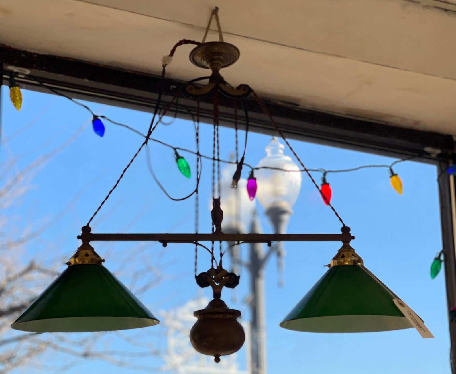 c1900 Double Pull Down Brass Billiard Light: Emerald green case glass shades, counter balance. Overall good condition. Appears to have been rewired. Measures 23 inches high (up) and 48 inches (pulled down), 27 inches wide. Shades are 10 inches i