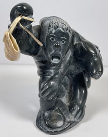 Johnny Aculiak (1951 - 2008) Man Putting Boots on Dog Stone Sculpture