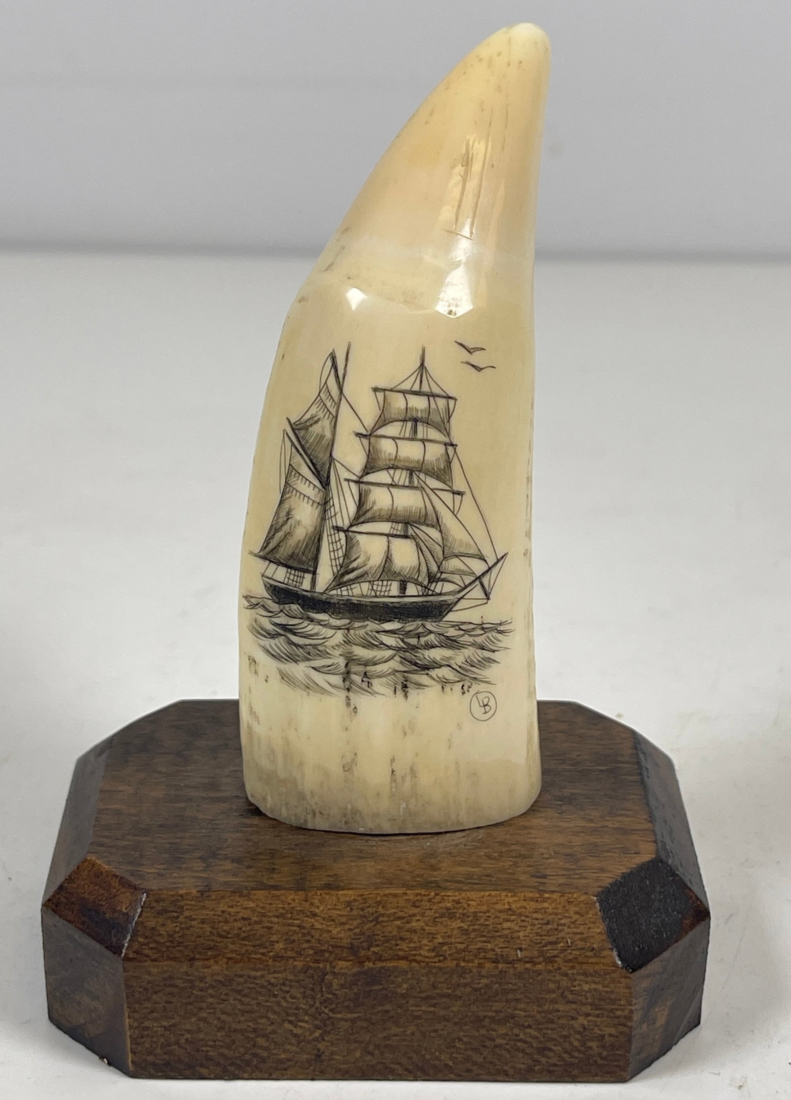 Vintage Scrimshaw Schooner on Whale Tooth signed L.B.: Mounted on wood base. Measures 3.75 inches high, octagonal base is 2.75 x 2 inches.
