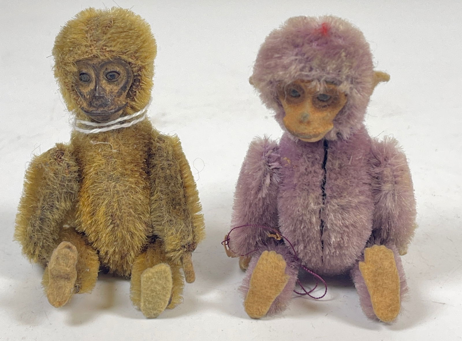 Lot of 2 Schuco Monkey Perfume Holder & Compact: Purple monkey has compact, tan monkey is perfume. Measure 3.5 inches long. Overall fair condition, please see photos.