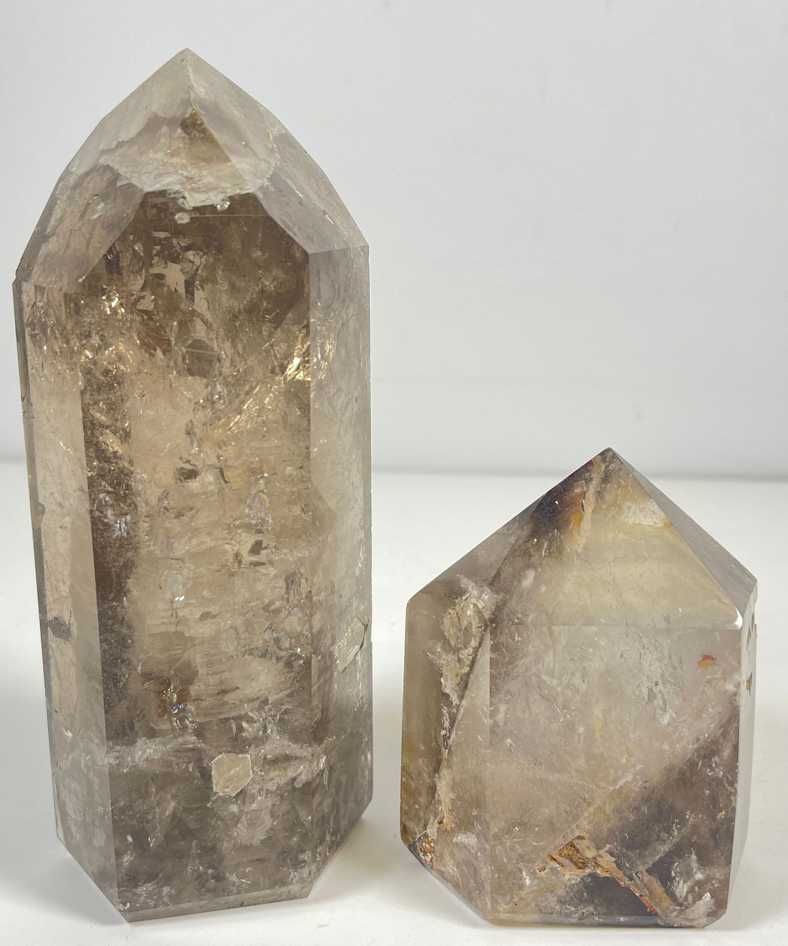 Lot of 2 Rutilated Smoky Quartz Crystalline Obelisks: One measures 6 inches high (848 grams), the other measures 3.25 inches high (484 grams).