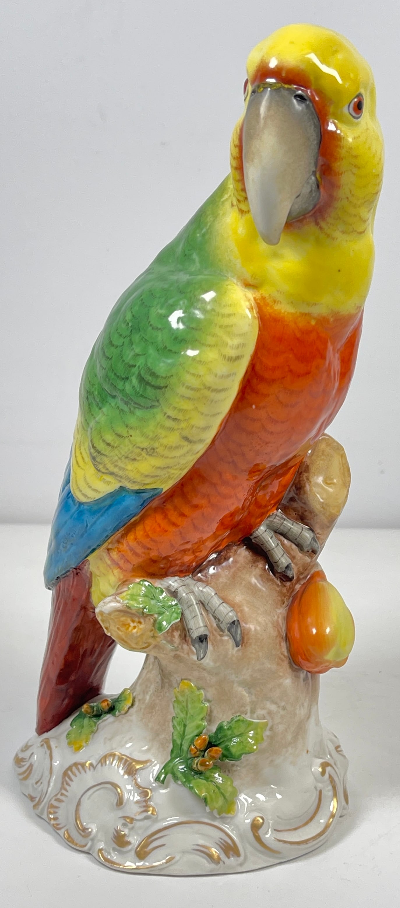 19th Century Manner of Meissen German Porcelain Parrot: Multi colored parrot, marked Germany. Measures 9.5 inches high, 3.75 inches wide, 4.5 inches deep. Overall good condition, some chipping to the leaves, please see photos.