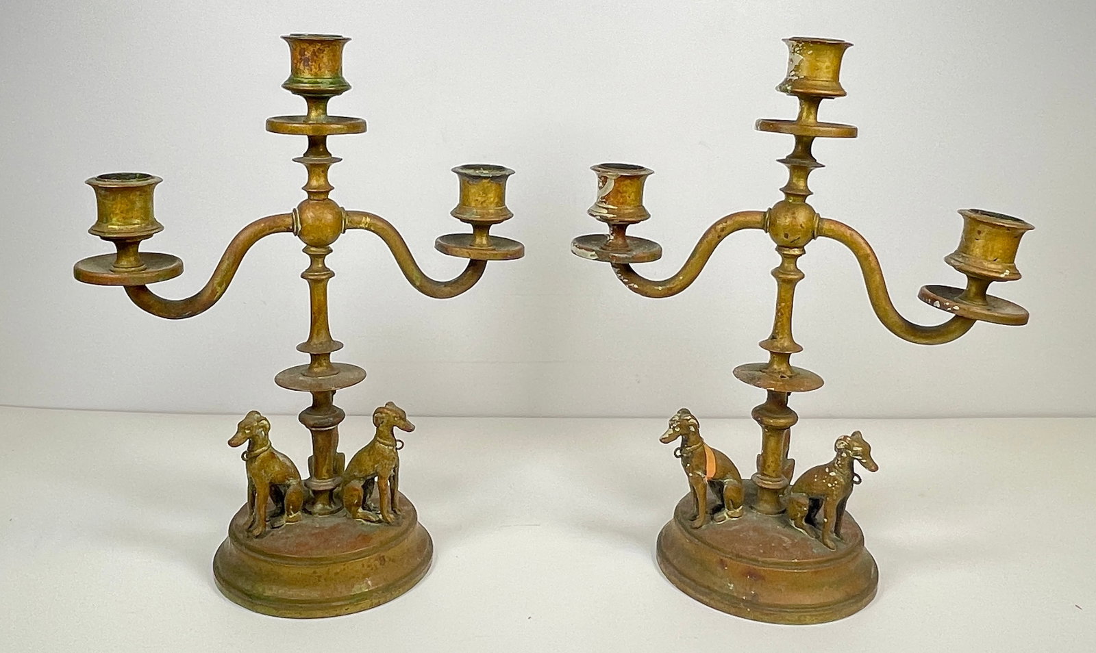 Victorian Brass Candlesticks With Whippet Dogs: Three dogs on each candlestice. They measure 10.5 inches high, 8.25 inches wide. Overall good condition.