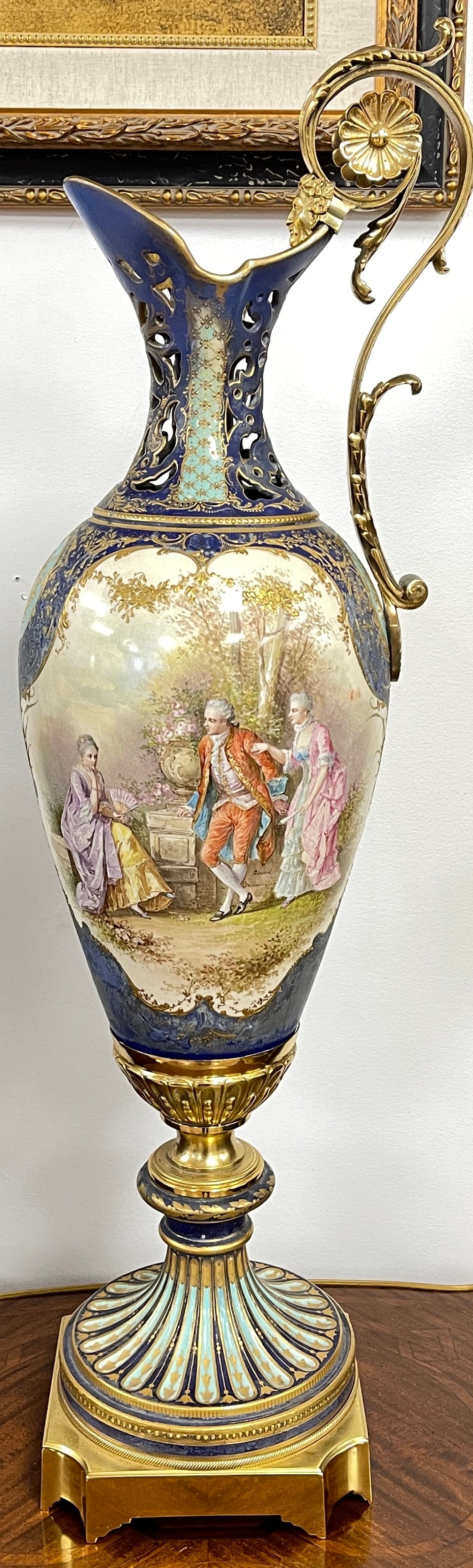 Monumental Sevres Style Gilt Bronze Mounted Ewer: Cobalt blue with paintd scenes. Restoration to the top, please see photos. Overall good condition. Measures 37 inches high, 12 inches wide.