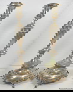 c1910 Pair Austrian Silver Candlesticks: Chased leaf design along the candlesticks, sitting on three feet. Measure 13.5 inches high, 6.125 inches across the bottom. Total weight approx 18.7 ozt. Overall good condition, please see photos.