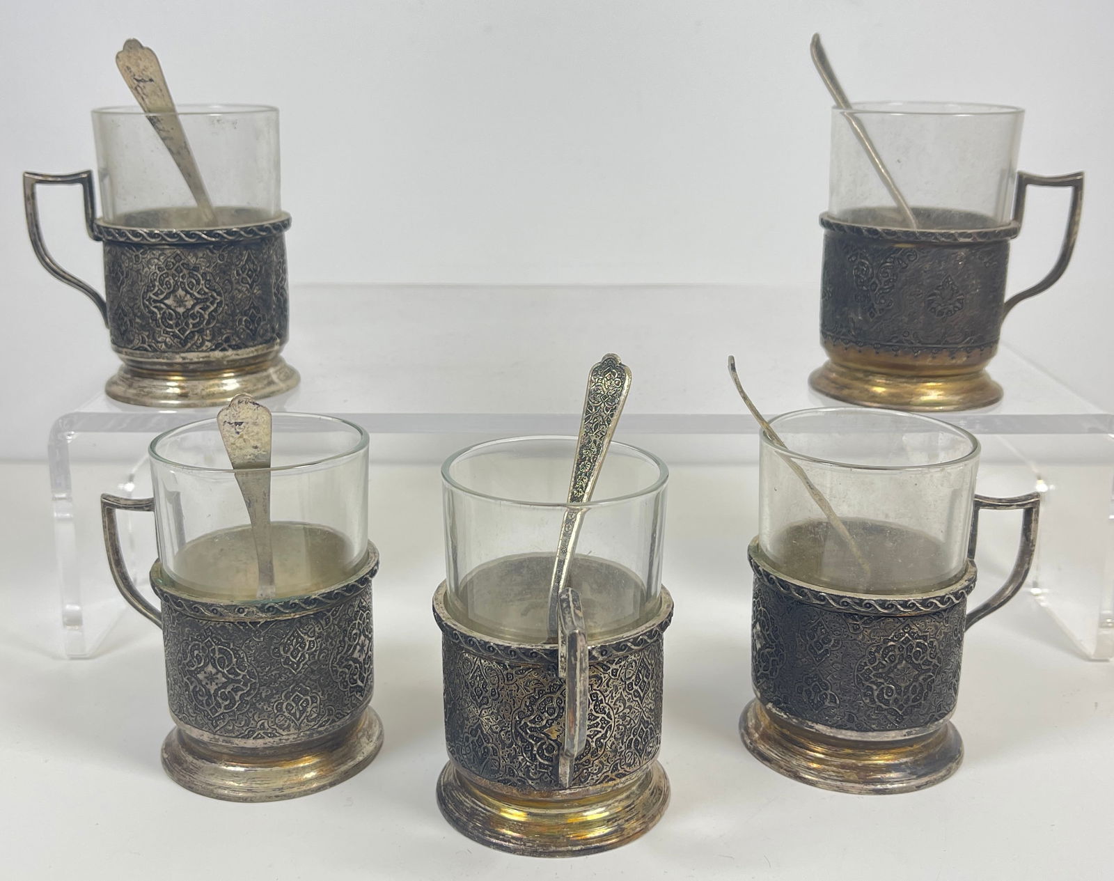 Lot of 5 Engraved Persian Silver & Glass Tea Cups w spoons: Measure 3 inches high. Marked 84 and another mark. Weight of silver is 378.3 grams. Overall good condition.