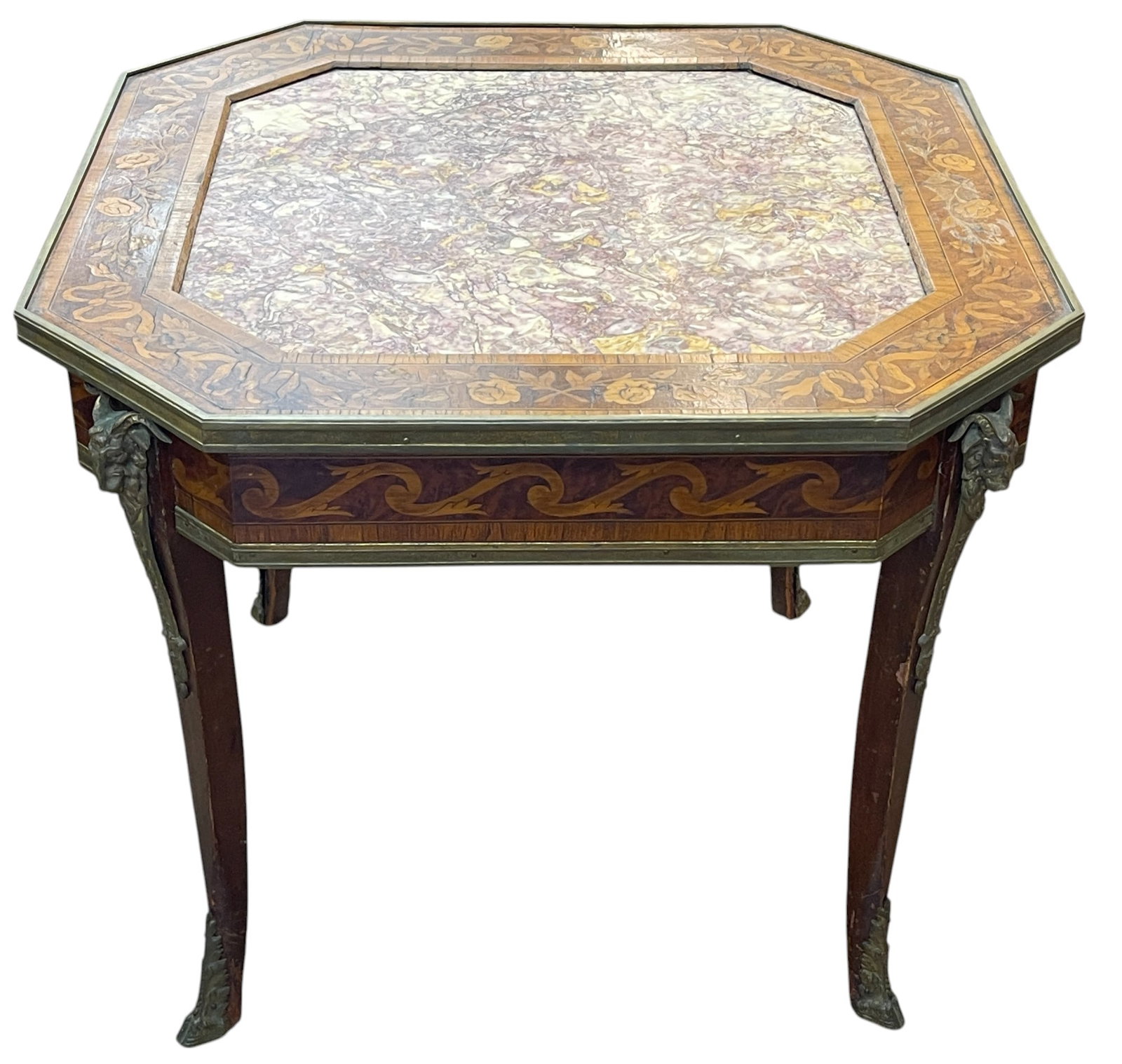 19th Century French Marquetry Bronze Mounted Table: Octagonal table with rams head bronze mounts, hoof mounts on the feet. Inset rouge marble. Overall good condition, please see photos. Table measures 23 inches high, 26.5 inches across top.