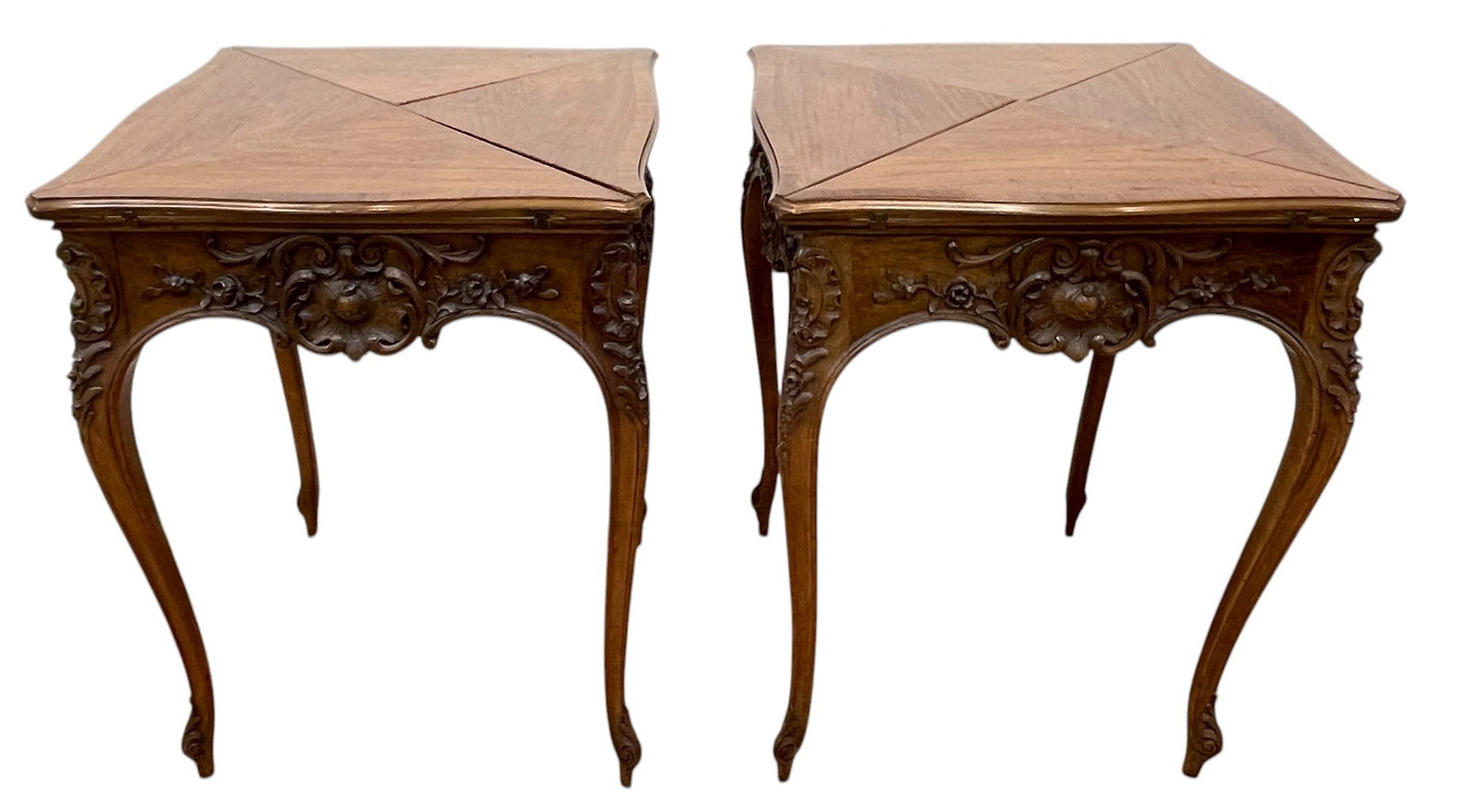 Pair of Walnut Carved Hankerchief Flip Top Game Tables: Banded tops with green felt underneath. Overall fair condition, sun fading to spots please see photos. Measures 30 inches high, 23 inches square.