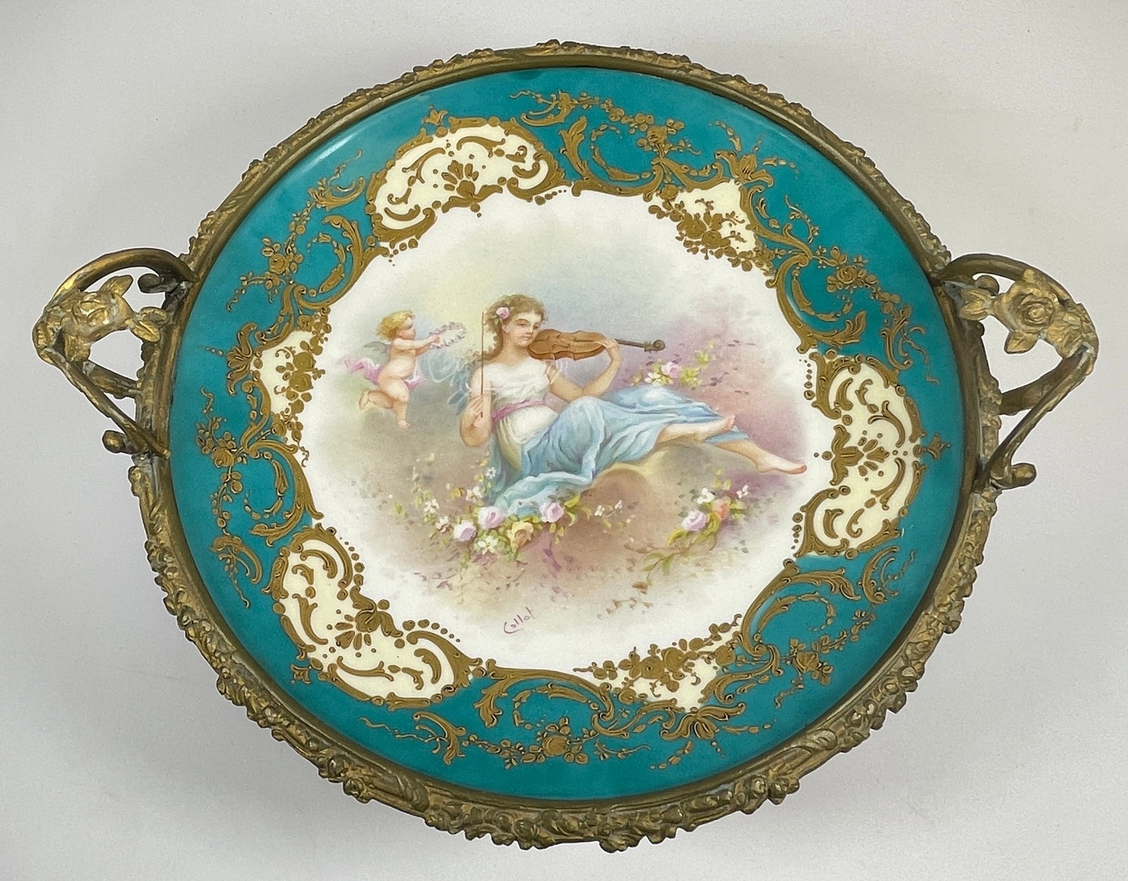 French Sevres Bronze Mounted Chateau des Tuileries Centerpiece: Antique French Sevres Hand Painted and Bronze Mounted Chateau des Tuileries Center Piece with Gilt Highlights and Artist Signed Collot Center Panel of cherub bringing halo of flowers to woman playing 