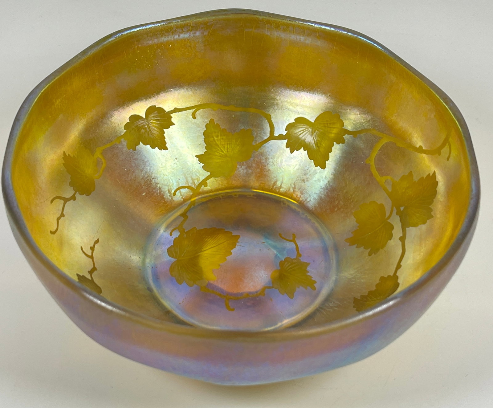 19th Century Louis Comfort Tiffany Favrile Leaf Pattern Bowl: Favrile bowl, iridescent glass decorated with leaf and branch pattern, signed 'L.C.T. Favrile'. Measures appros 8 inches in diameter, 3.25 inches high. Overall good condition, no chips or cracks.