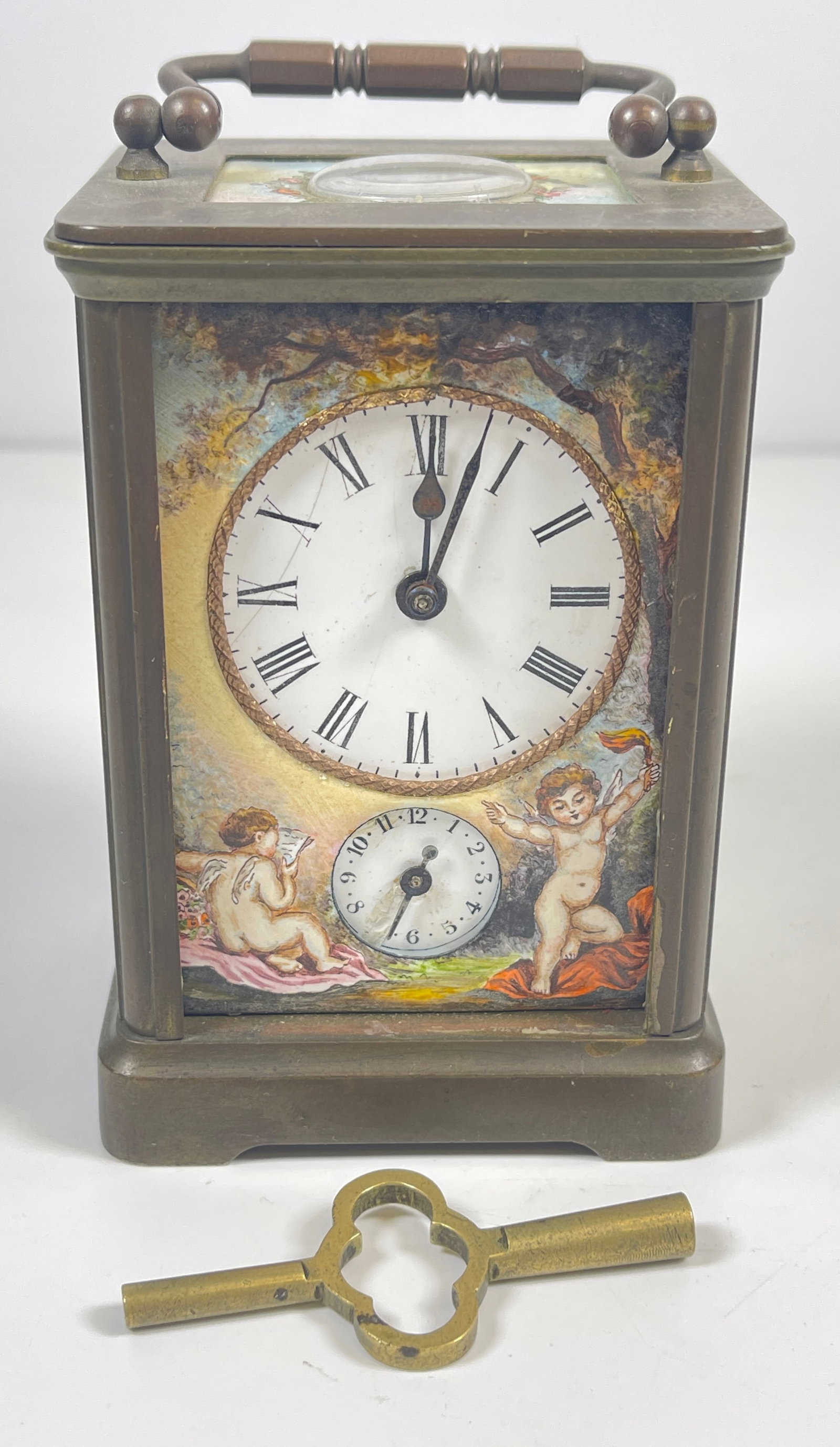 c1870 French Brass & Courtship Scene Enamel Carraige Clock: Cherubs on the front, courtship scenes on the sides and back. Porcelain face has a scratch. Enamel in excellent condition, clock running at time of listing. Clock measures 4.25 inches high (not includ