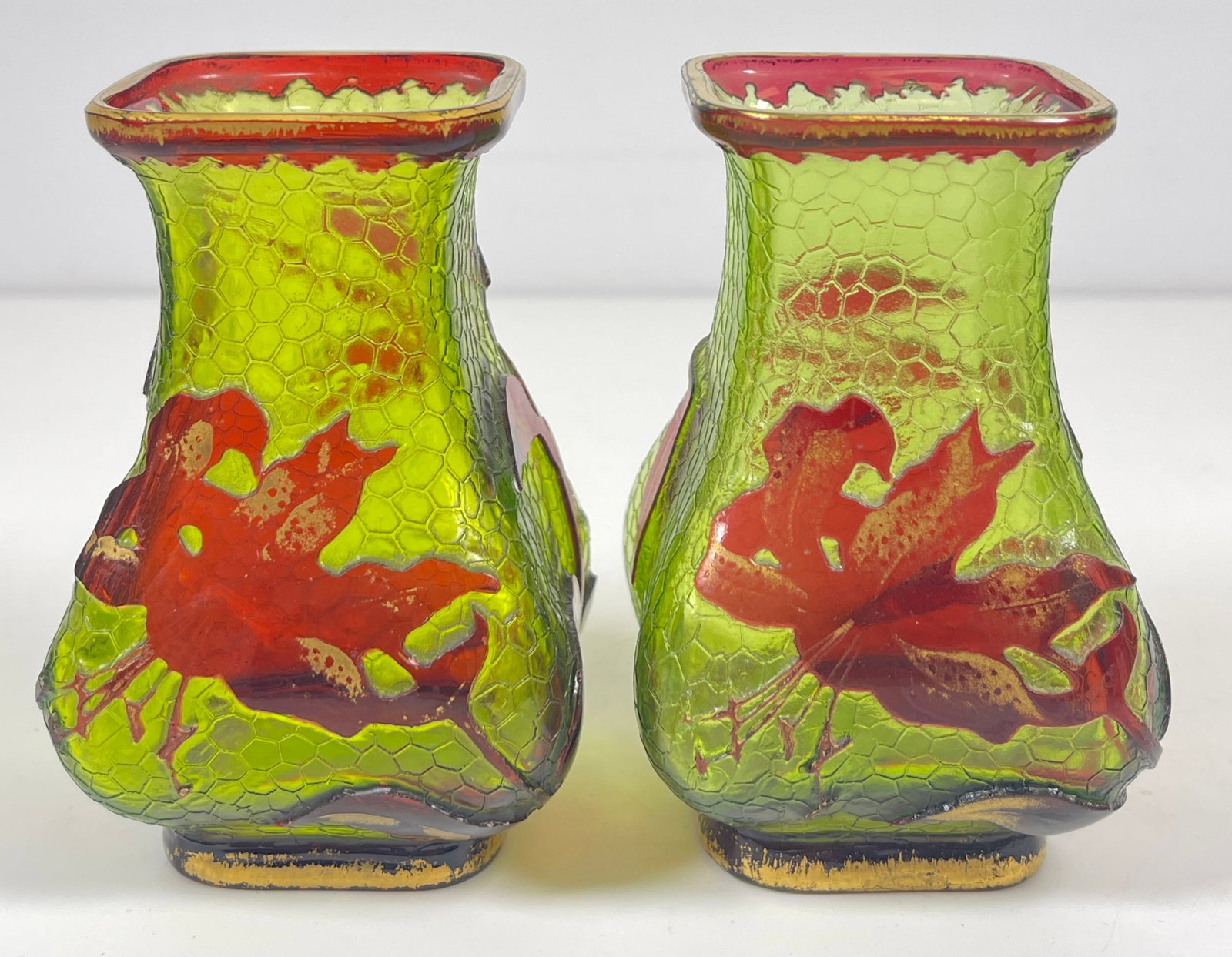 Pair Art Nouveau Baccarat Crackle Cameo Art Glass Vases: A floral decorated red and green example with gilt elements, unmarked. One has Christie's label on the bottom. Measure approx 2.25 inches square, 4 inches high. Overall good condition, no chips or cra