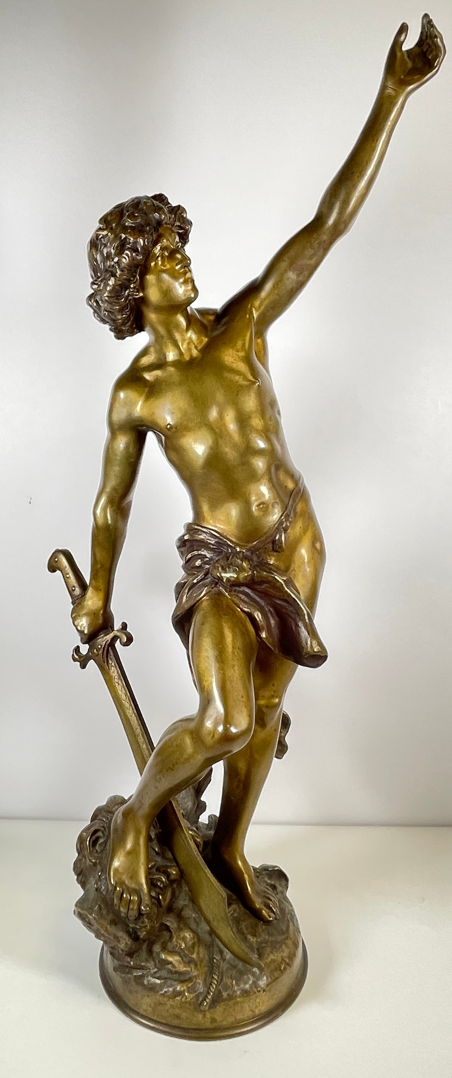 Louis Gossin (1846-1928) Bronze 'Victorious David': Sculpture in patinated bronze representing victorious David. Measures 27 inches high, 9 inches wide, 9 inches deep.