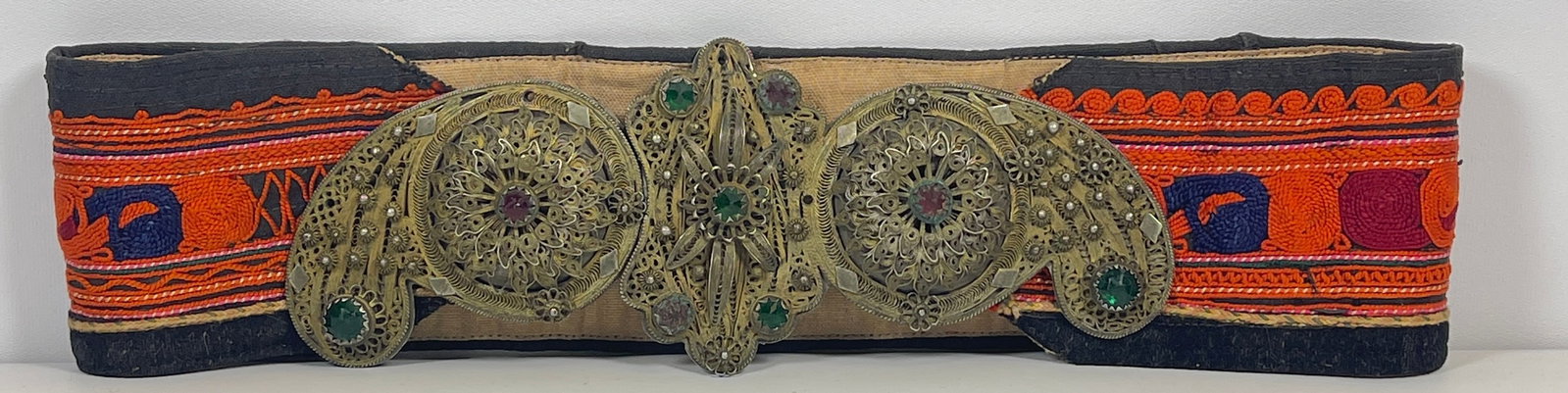 Antique Ottoman Filigree Decorated Ceremonial Belt: Solid metal frame with applied filigree decoration, green and red glass stones. Some decorations missing, please see photos. Buckle measures 8 inches long. Belt measuress 26 inches long, 3 inches wide